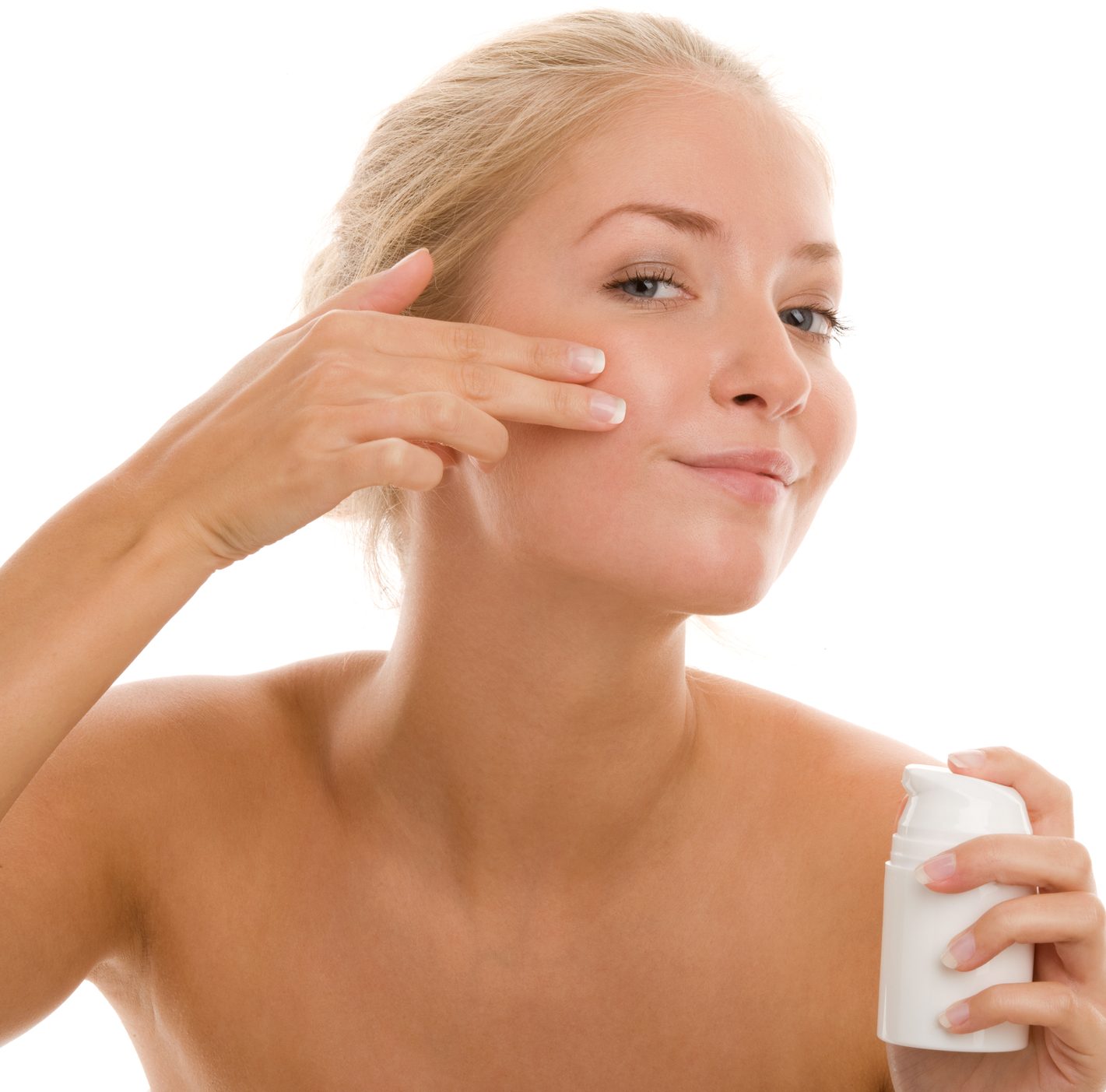 Woman applying cream on face