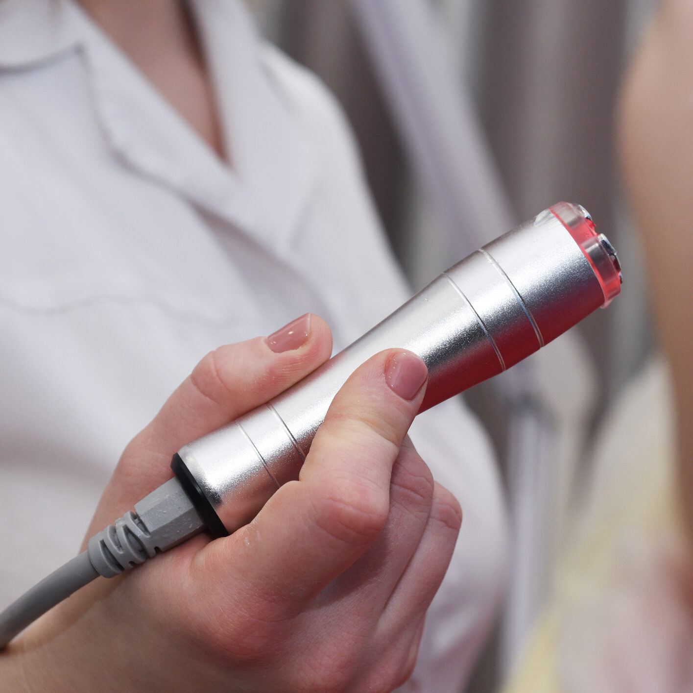Esthetician performing a radiofrequency skin tightening facial treatment