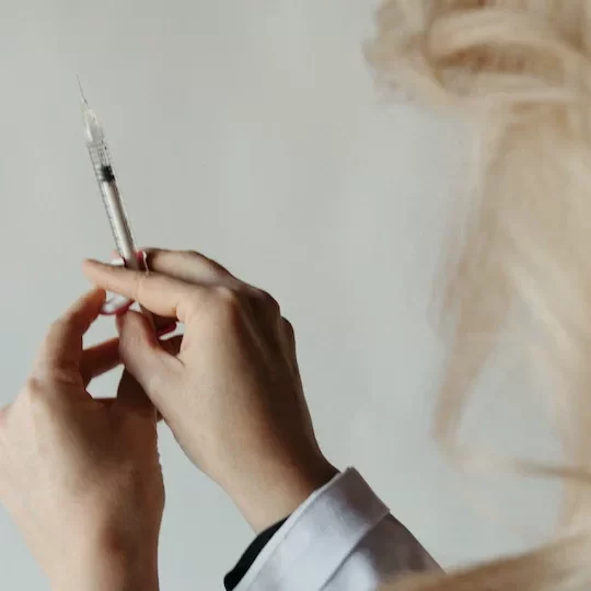 Dr Natalya holding a syringe
