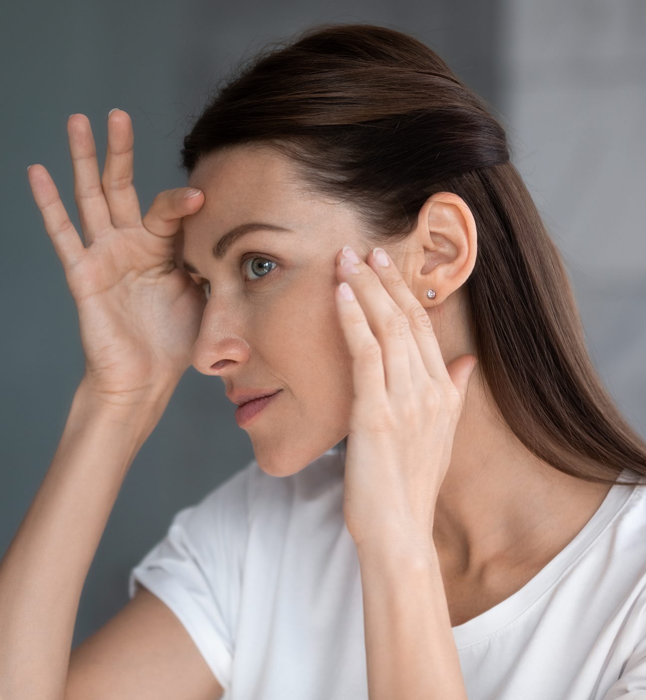 woman looking in mirror