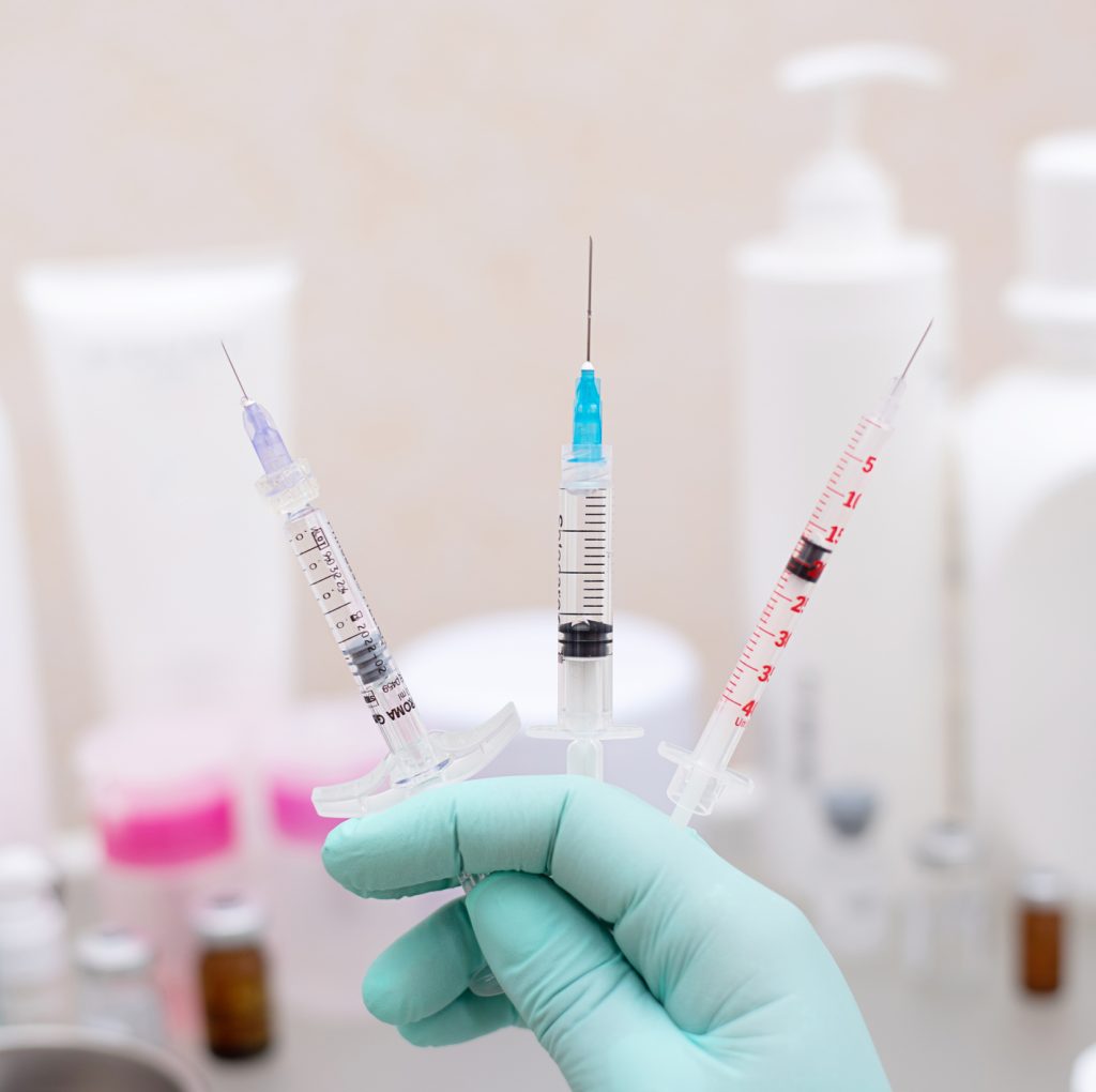 three syringes with cosmetic rejuvenating injections