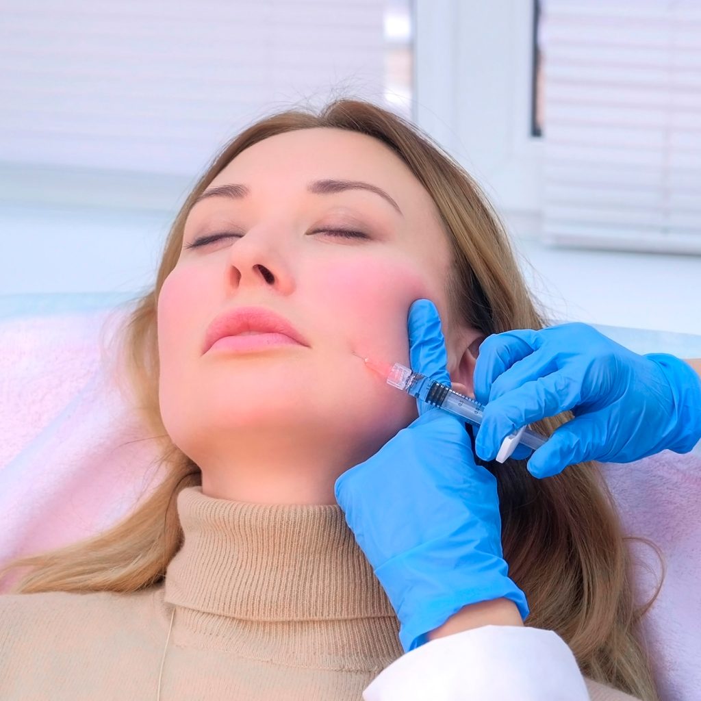 Doctor-cosmetologist-makes-injection-with-filler