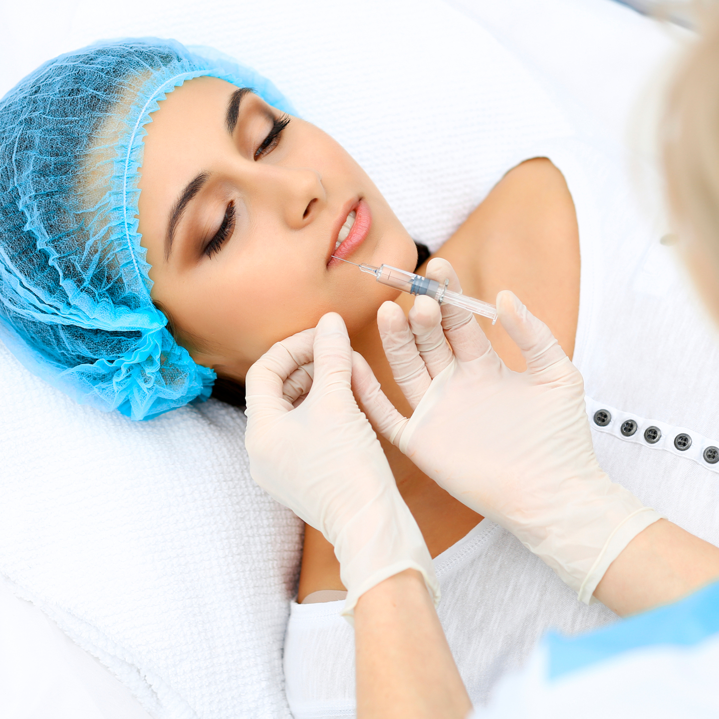 Lip filler injection in progress — hyaluronic acid dermal filler administered to a patient's lips at Desert Bloom Skincare, Scottsdale
