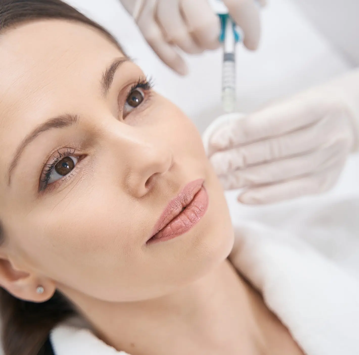 Woman receiving facial beauty injection in cosmetology clinic